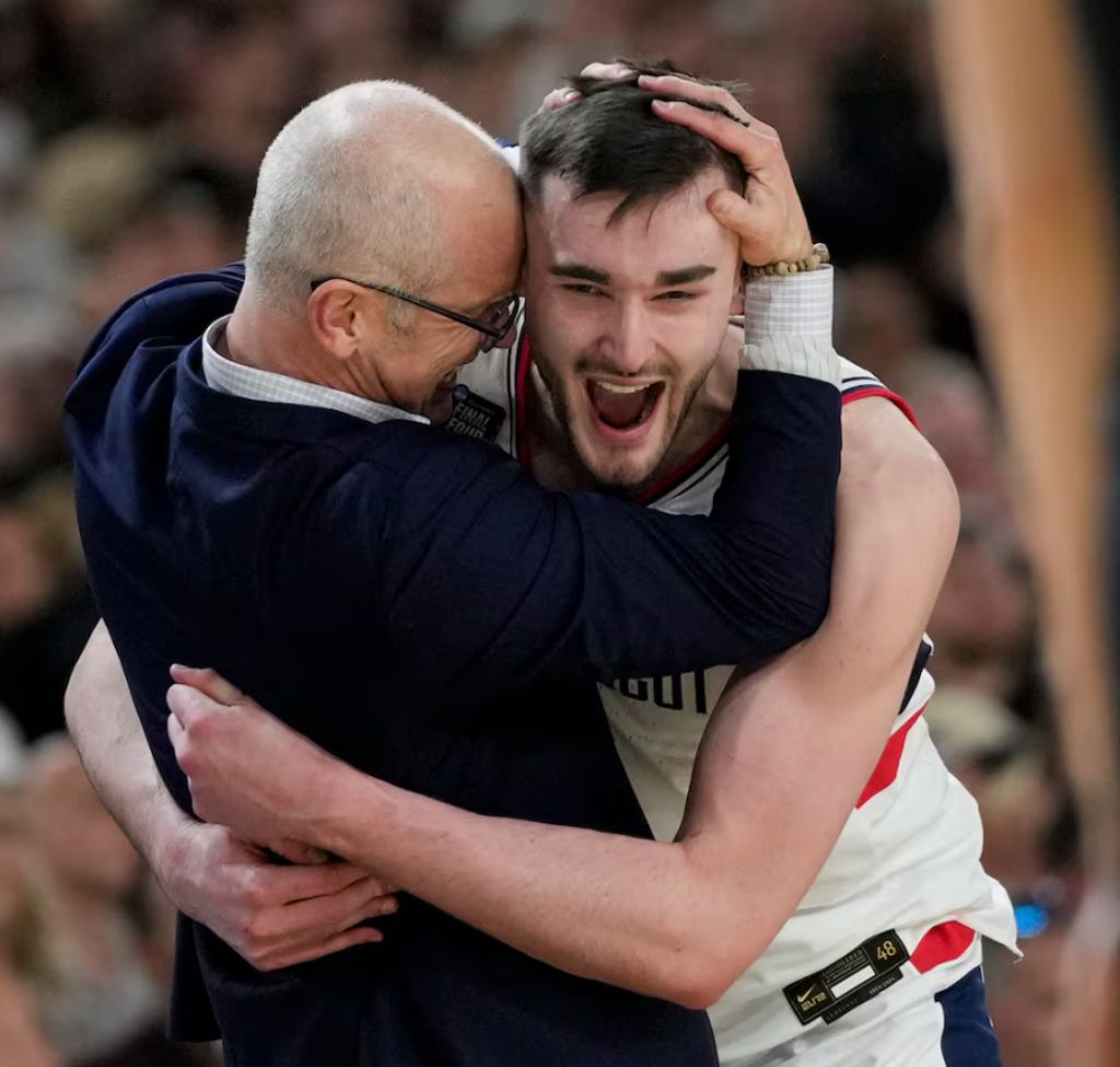 Alex Karaban hugging his coach