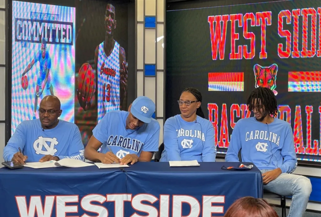 Jalen Washington picture while signing a contract