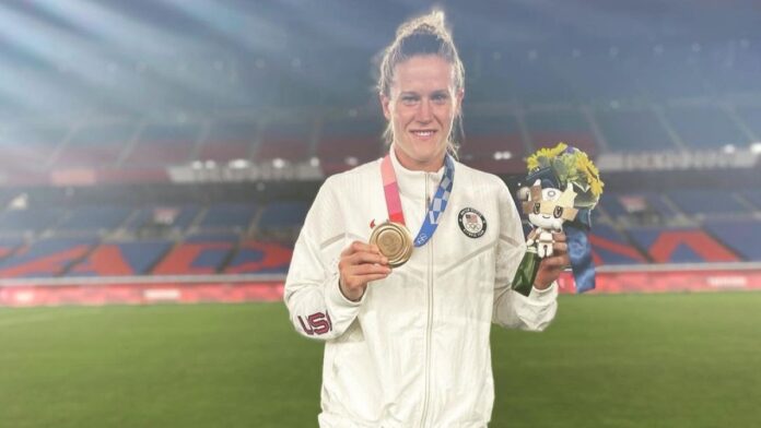 Alyssa Naehar holding her medal and bouquet of flower