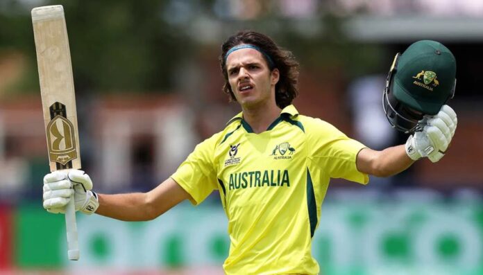 Sam Konstas holding his cricket bat and cap